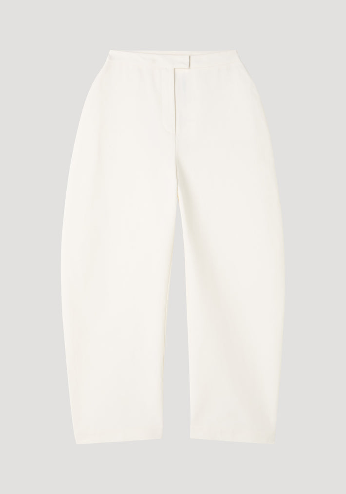 Sculptural trousers in paper white, featuring a high waist and bold balloon legs, crafted from structured cotton with a satin finish.