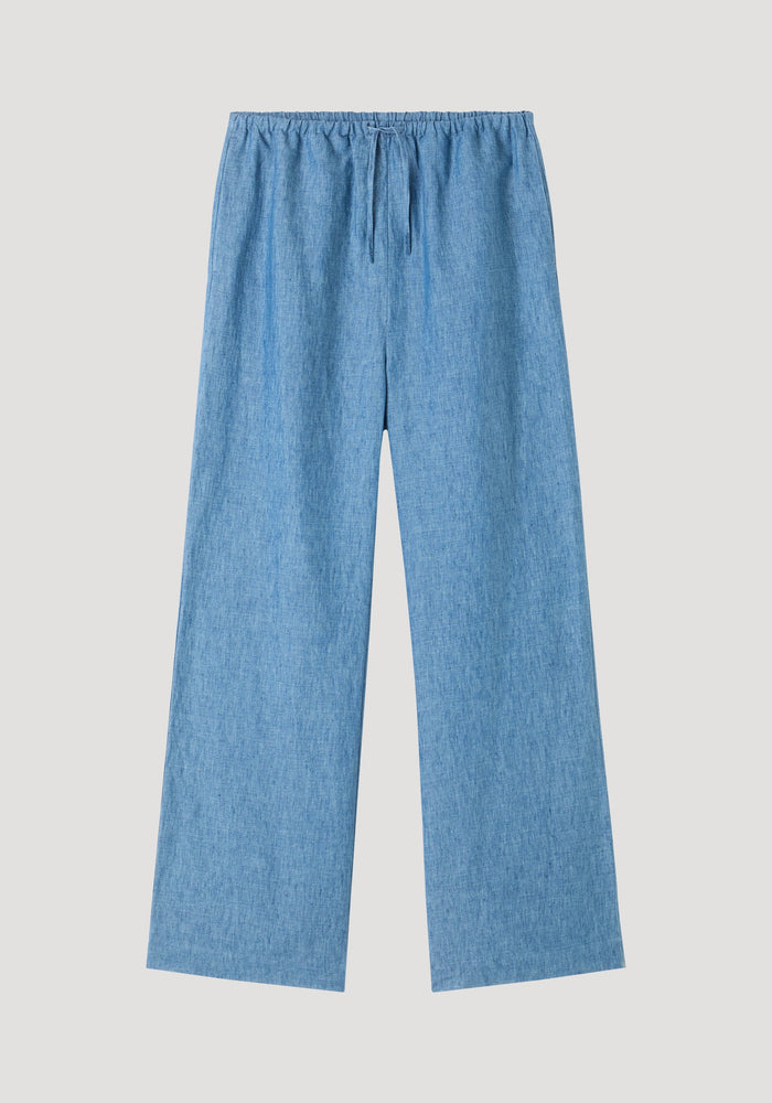 Relaxed fit trousers in ocean blue, featuring wide legs, elasticized drawstring waistband, and side seam pockets, crafted from soft chambray-style linen.