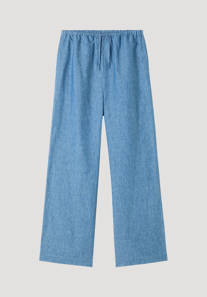 Relaxed fit trousers in ocean blue, featuring wide legs, elasticized drawstring waistband, and side seam pockets, crafted from soft chambray-style linen.