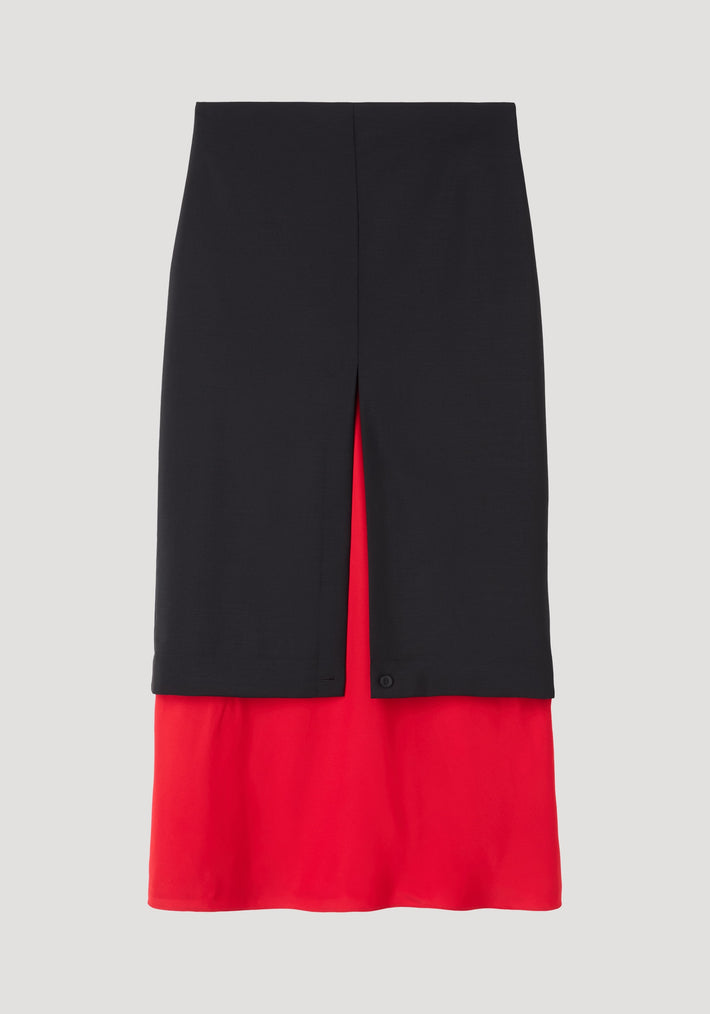 Contrast upside-down skirt | black features a knee-length black overlay with a center slit, revealing a bold red under-skirt, tailored for a striking silhouette.