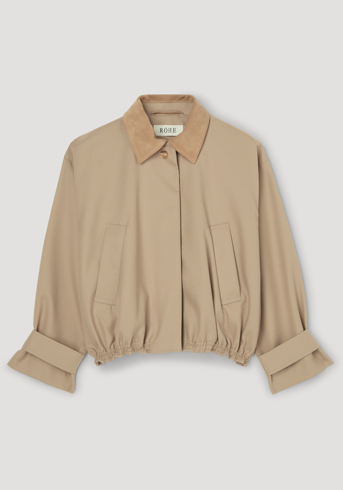 Suede collar blouson jacket | sand features a cropped, boxy silhouette with suede collar, vertical welt pockets, and elastic hem. Wide sleeves have strap detailing.
