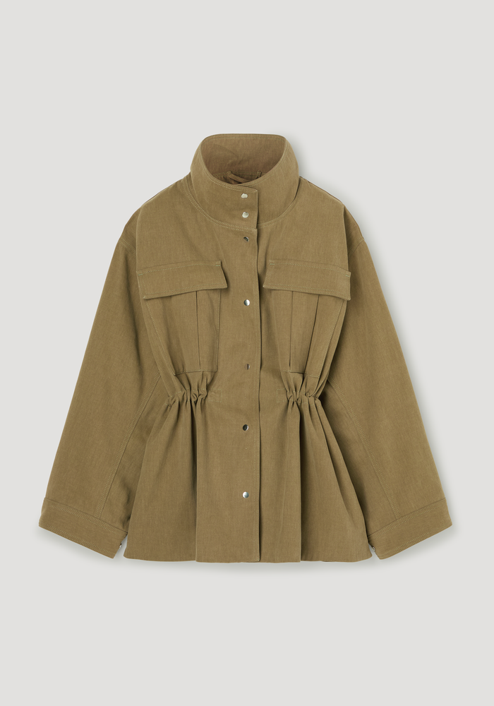 Sculptural safari jacket in sage featuring a stand-up collar, snap-front, chest flap pockets, and a cinched waist for a defined silhouette.