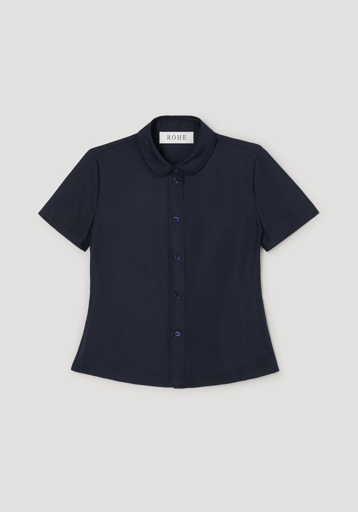 Embroidered silk fitted shirt | night, showcasing a navy, short-sleeve blouse with a Peter Pan collar and delicate embroidery, laid flat with visible RÓHE label.