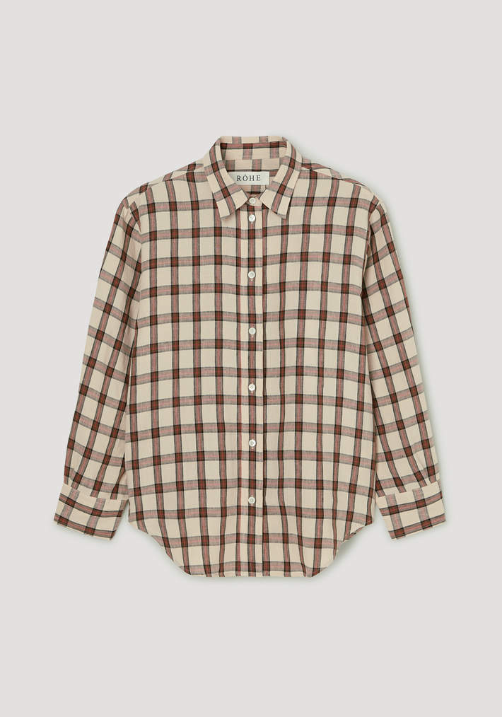 Oversized check shirt in beige plaid with red and black lines, featuring a relaxed fit, classic collar, white buttons, and a gently curved hem.