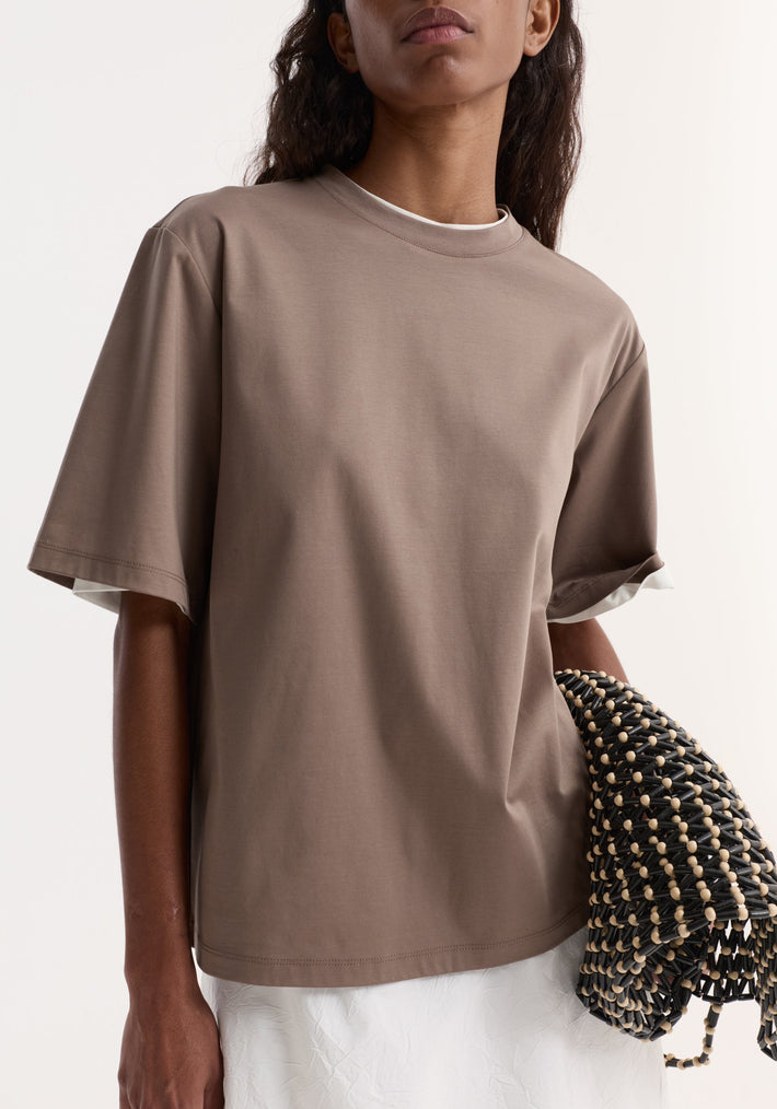 Oversized taupe T-shirt in a cotton-silk blend, featuring dropped shoulders and a crew neck, paired with a woven tote.
