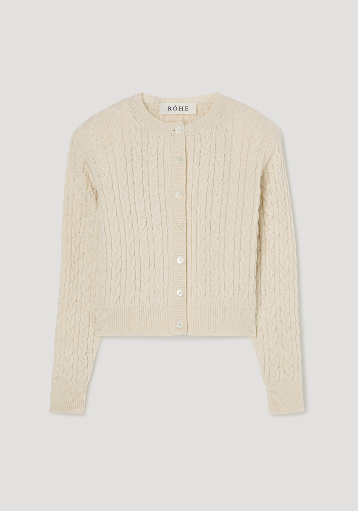 Fine merino cable cardigan | cream, featuring a round neckline, long sleeves, pearl-like buttons, subtle shoulder pads, and a slightly cropped, cable-knit design.