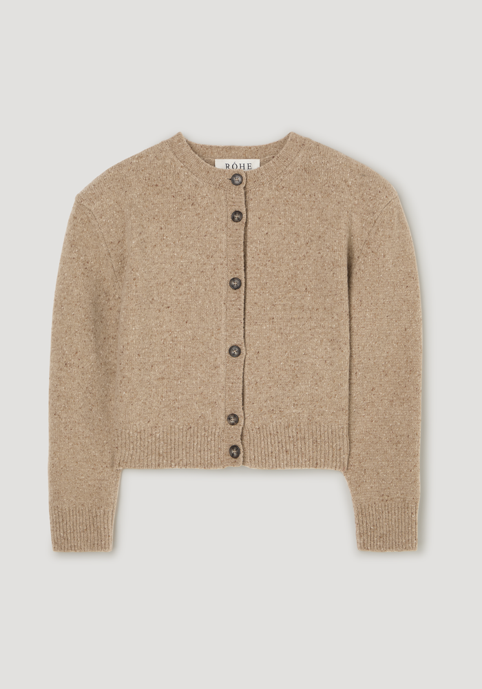 Fine merino tweed cardigan in oat melange, featuring a crew neckline, ribbed cuffs, dark buttons, slightly cropped fit, and shoulder pads, made of 100% merino wool.