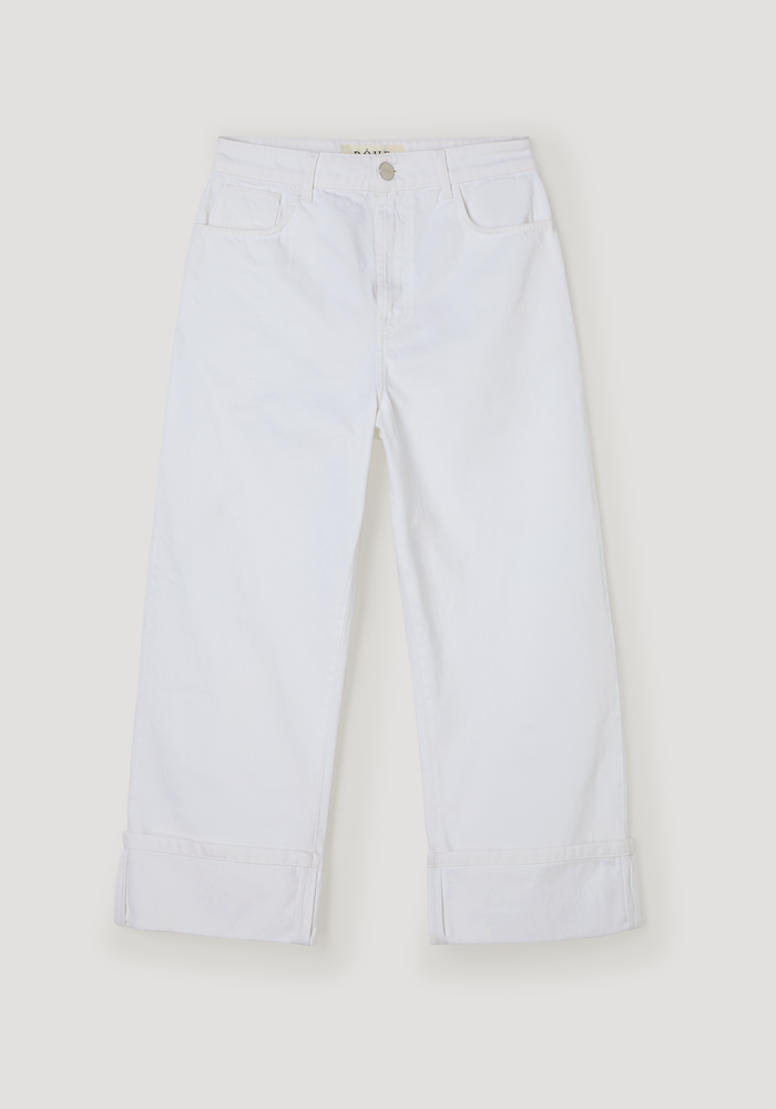 Baggy fit turn-up denim in optic white, featuring a low-waist, wide-leg design with rolled cuffs, silver button closure, and front pockets, made of 100% cotton.