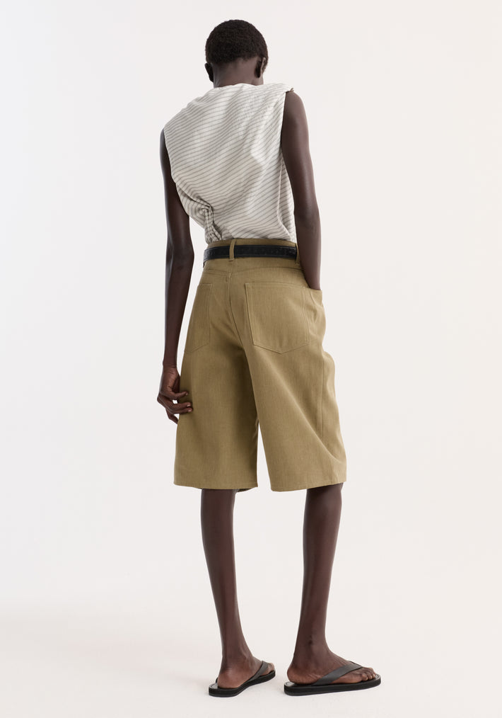 Model in Baggy Fit Denim Shorts | Sage, showcasing high-waisted, knee-length design with patch pockets and a relaxed, casual fit, paired with a pinstriped top.
