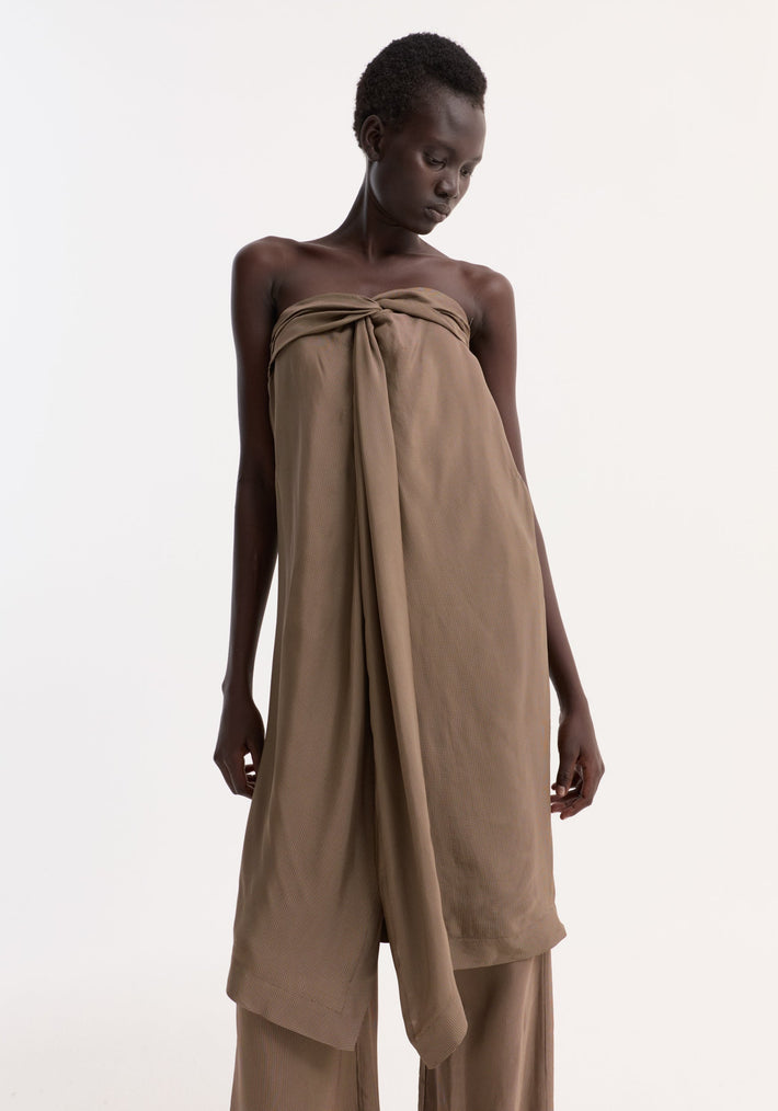 Model in Sarong top with knot detail and front slit, paired with matching wide-leg trousers, showcasing the garment's draped elegance and inner bustier structure.
