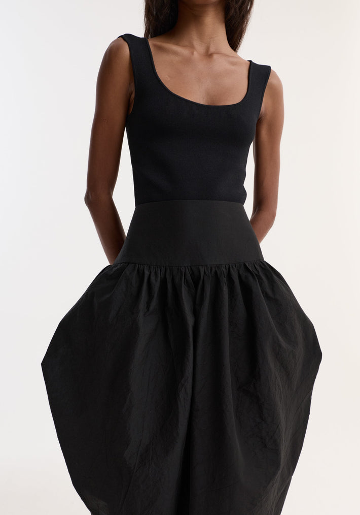 Model wearing Sculptural volume skirt | black, featuring a fitted waistband and architectural pockets, forming a bubble silhouette with a mid-waist design.