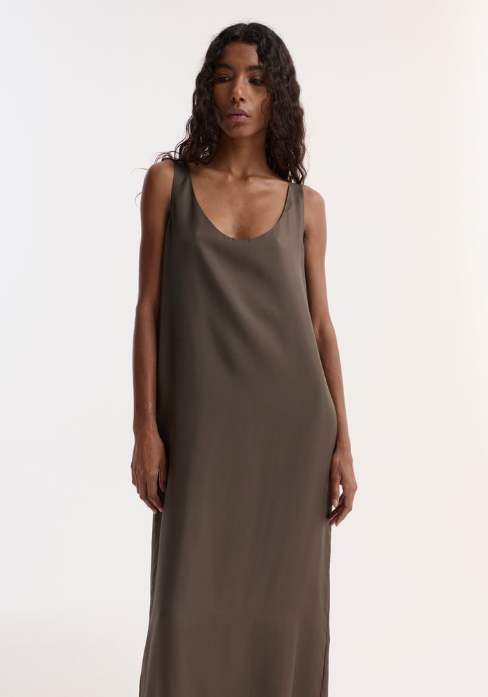 Woman wearing a Silk Scoop-Neck Dress | Earth, featuring a sleeveless, floor-length design with a deep scoop neckline, crafted from pure silk for a relaxed silhouette.