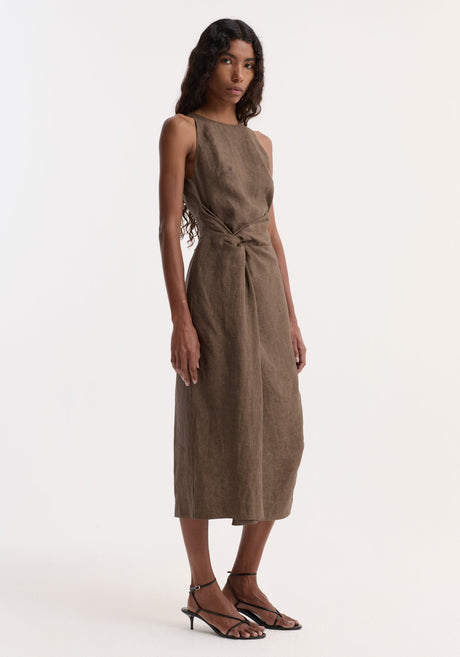 Model wearing Sarong dress | brown melange, sleeveless, calf-length, with high neck and back, featuring a waist knot. Paired with black strappy heeled sandals.