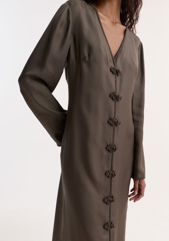 Woman wearing Pankou closure silk dress | earth with full-length sleeves, V-neck, frog-style buttons, high front split, crafted from pure silk.