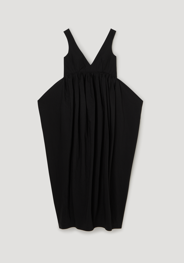 Sculptural textured cotton dress in black, featuring a sleeveless V-neck with low back and a voluminous, balloon-style skirt gathered above the waist.