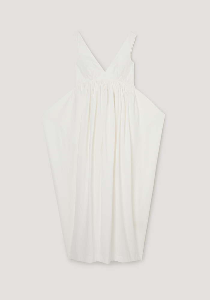 Sculptural textured cotton dress | off white: Sleeveless, deep V-neck dress with a fitted bodice, gathered waist, and voluminous trapezium-shaped skirt made from lightweight, crinkled fabric.