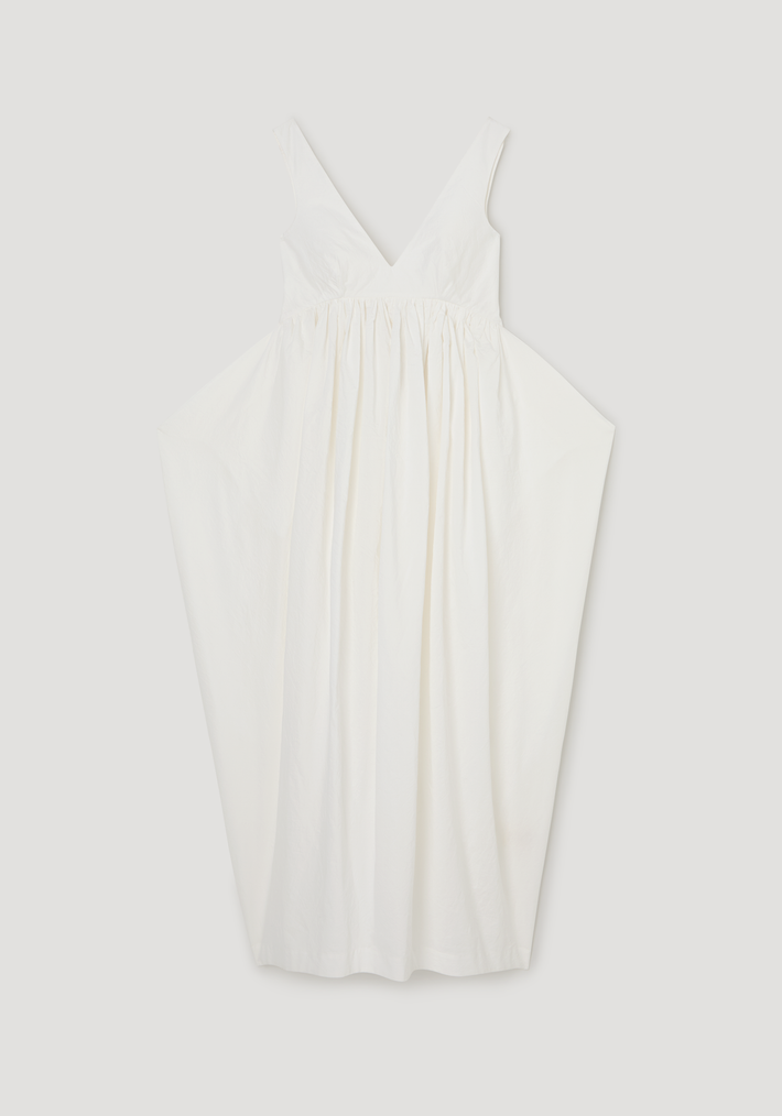 Sculptural textured cotton dress | off white: Sleeveless, deep V-neck dress with a fitted bodice, gathered waist, and voluminous trapezium-shaped skirt made from lightweight, crinkled fabric.