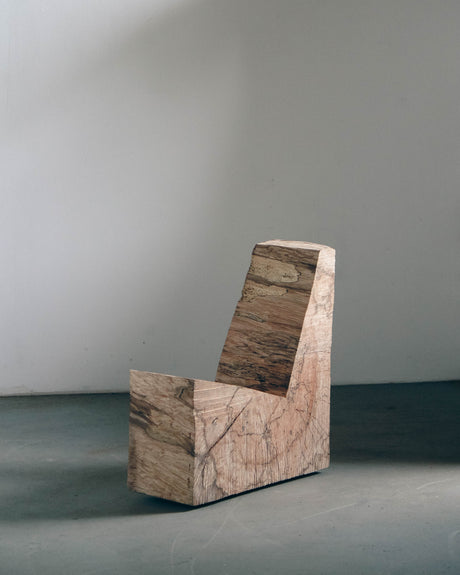Brutalist Chair | 5788: A raw, L-shaped oak wood block, showcasing rough chainsaw cuts, exemplifying minimalist design by Arne Kristian, blending sculpture with functionality.