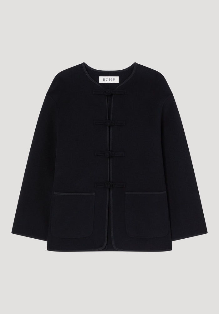 Mandarin double-faced wool jacket with pankou closures, embroidered edges, patch pockets, and a straight-cut design showcasing Róhe's artisanal craftsmanship.