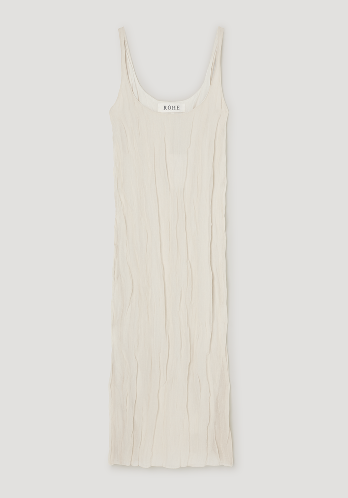 Textured square neck dress in cream with spaghetti straps, subtly crinkled fabric, and a scooped neckline, featuring a unique shapeable metallic yarn blend.