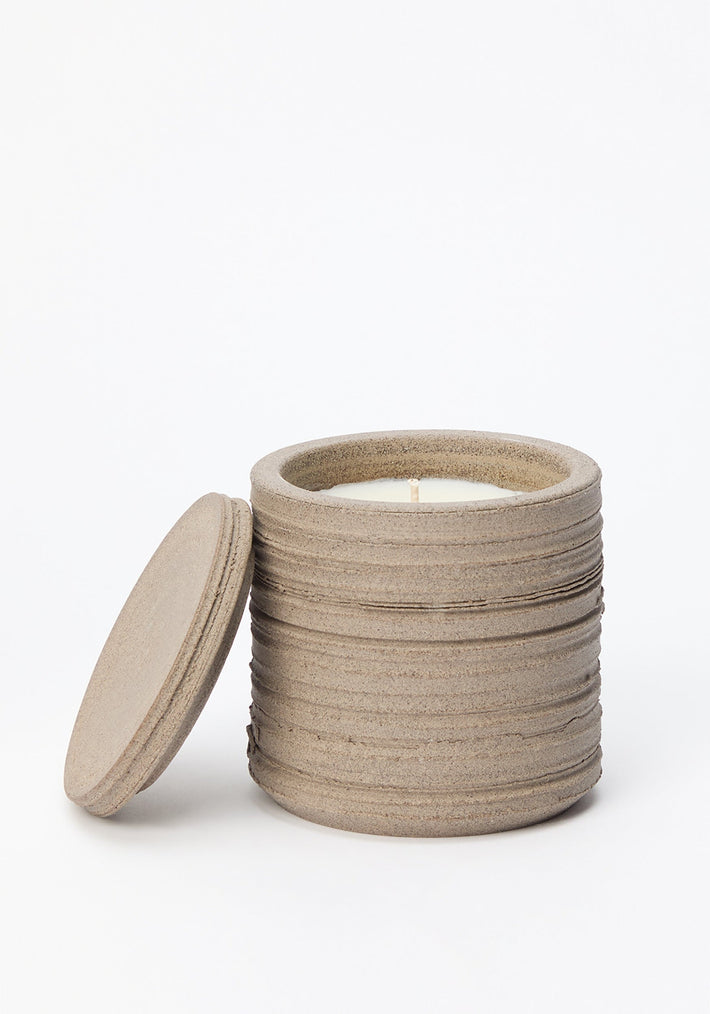 Diplomatico Scented Candle | stone: A handmade textured ceramic jar with lid, containing white wax and wick, infused with Róhe’s woody-aromatic fragrance.