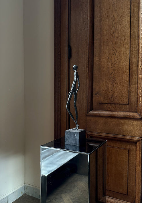 Bronze Sculpture | Quiet Confidence: A slender bronze figure walking, mounted on a block, showcasing Dutch artist Veri Wisman's impressionistic charm. Handcrafted in the Netherlands.