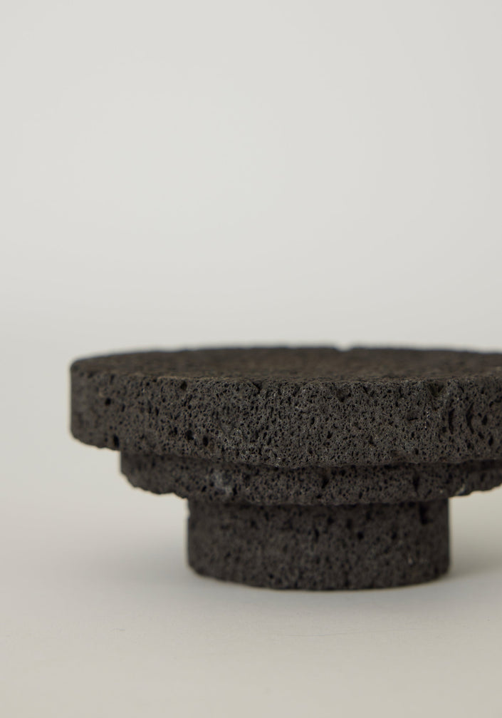 Elevated Sculptural Tray crafted from porous lava stone, featuring three stacked discs, showcasing a unique, handcrafted design by Dutch artist Louis Crombag.