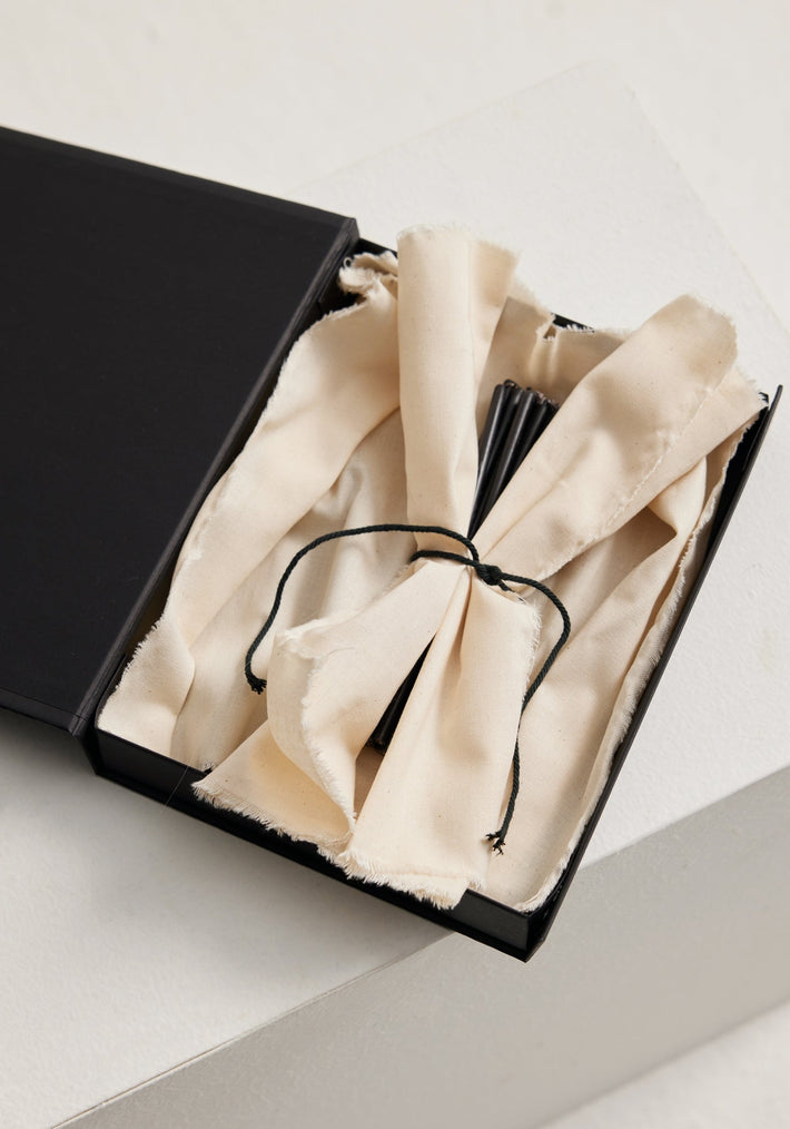 Candles 5mm | noir set in a matte-black gift box with a natural cotton lining, showcasing bundled long black candles made of 100% beeswax.