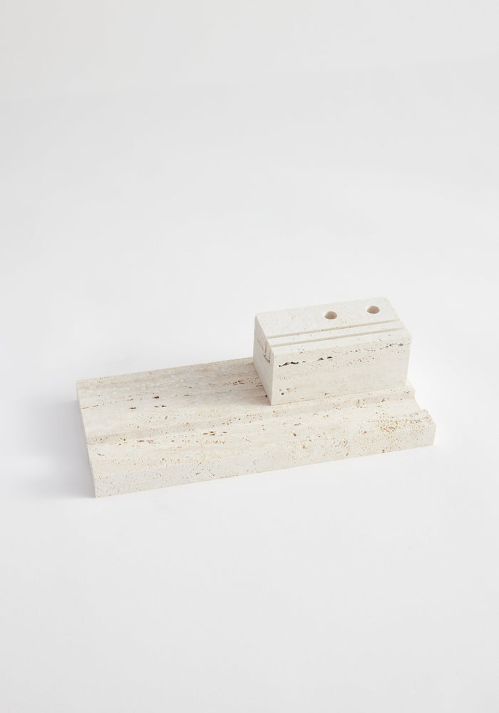 Desk organizer | travertine: Two-piece travertine set with a flat slab and smaller block featuring drilled holes, designed by Louis Crombag for organizing pens and paperwork.