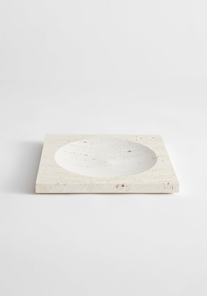 Medium tray | travertine: A handcrafted, square travertine tray with a central round indent, measuring 26cm x 26cm, made by Louis Crombag in the Netherlands.