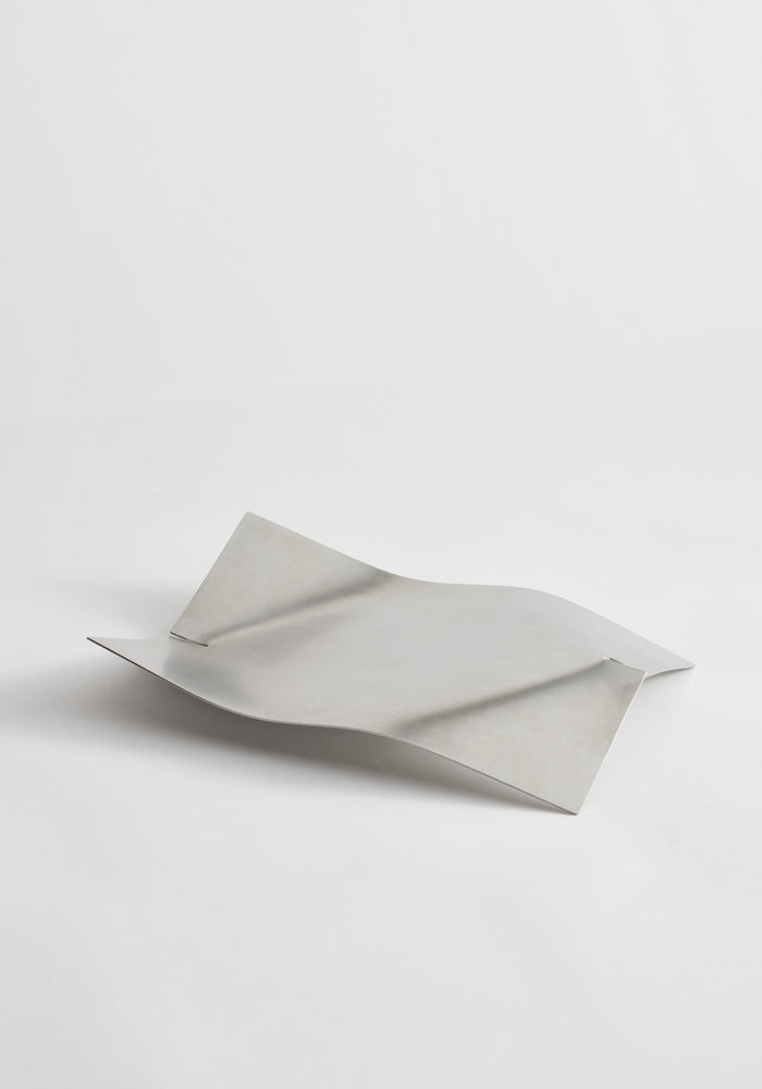 Stainless steel bowl, designed by Paul Coenen, with a wavy, bent form handcrafted in the Netherlands. Made from brushed stainless steel, measuring 32cm x 23.5cm x 5.5cm.