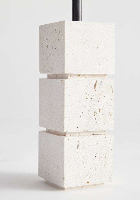 Sculptural candle holder small | travertine: Three stacked stone cubes with a black taper candle, handcrafted from Italian travertine by Dutch artist Louis Crombag.