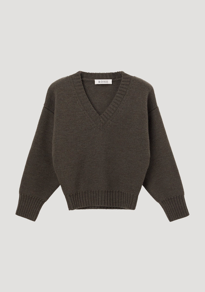 Sculptural compact v-neck | forest melange knit pullover sweater features a deep V-neck, dropped shoulders, ribbed cuffs, and hem, made from 100% wool by RÖHE.