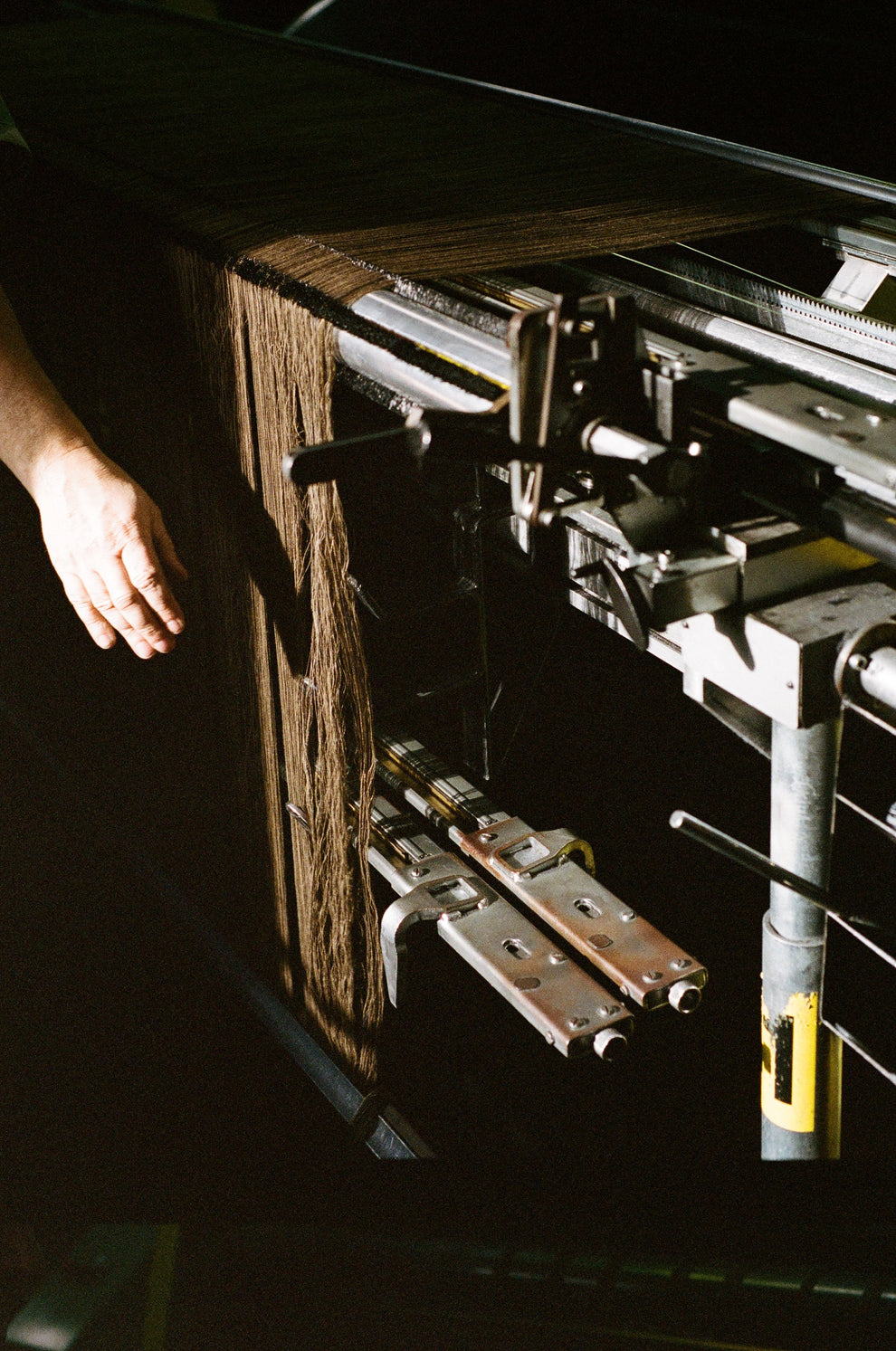 Person handling a weaving machine 