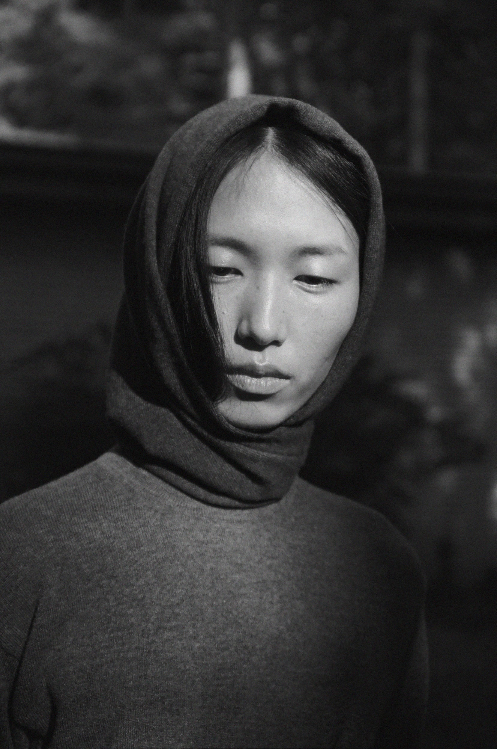 Portrait of a woman wearing a wool scarf wrapped around head in a black and white photo