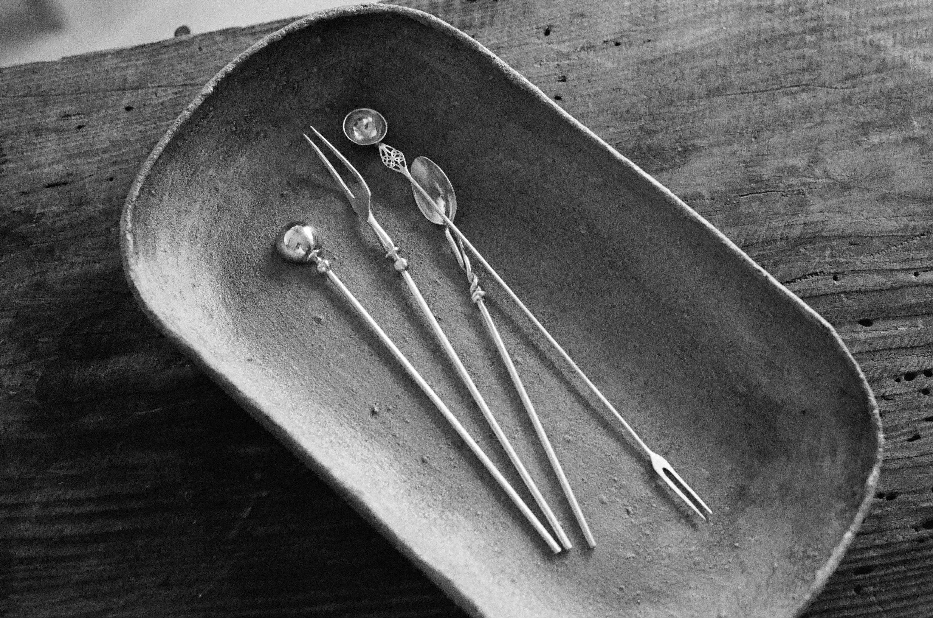 Small tray with delicate spoons and forks inside 