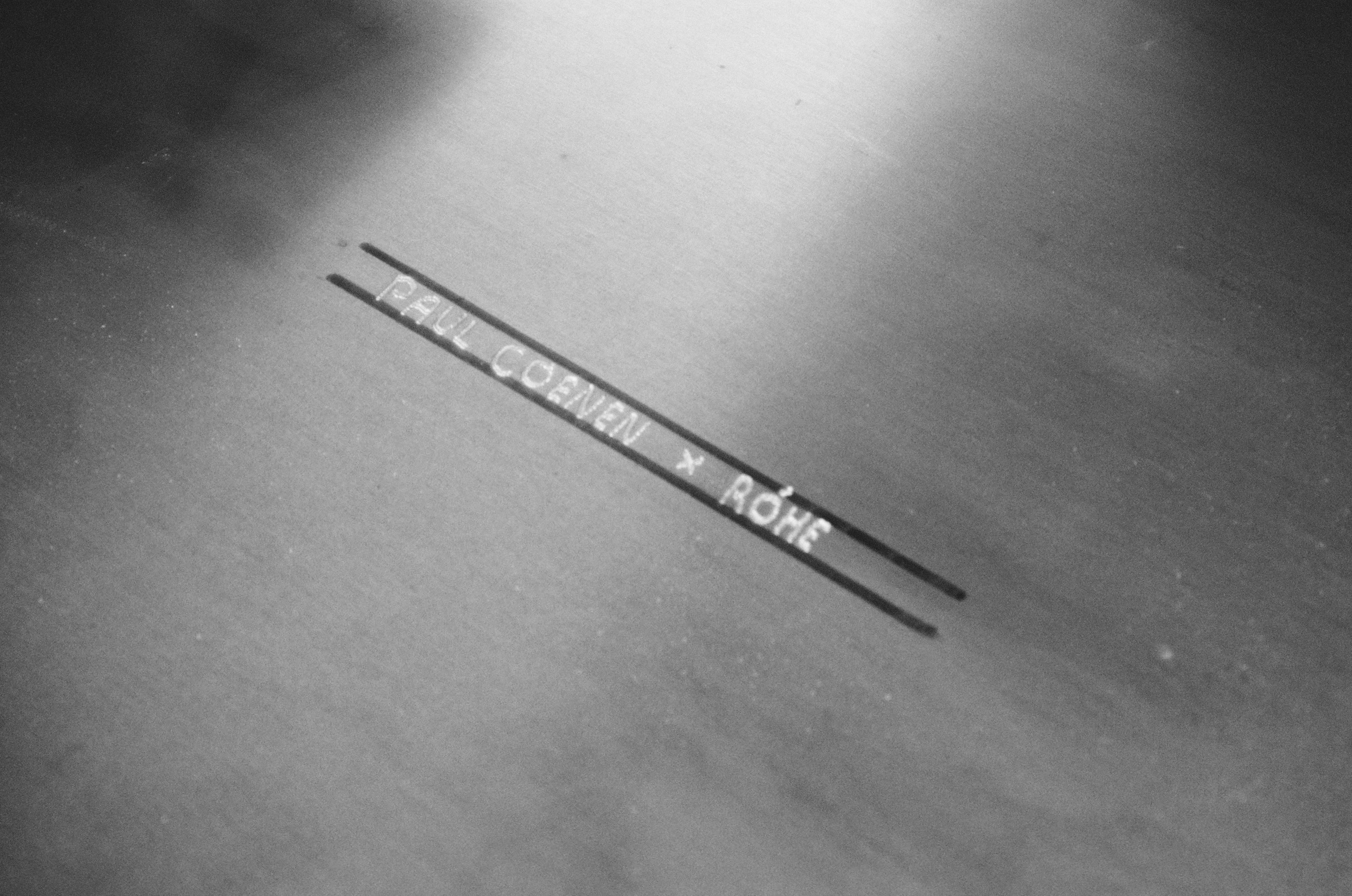 Stainless steel sheet with engraving saying "Paul Coenen x Róhe"