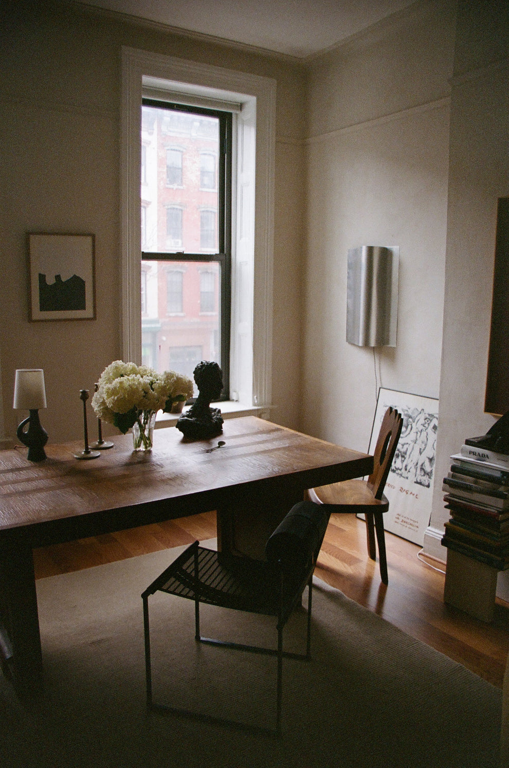 Wooden table in a room with design chairs, and decor elements.