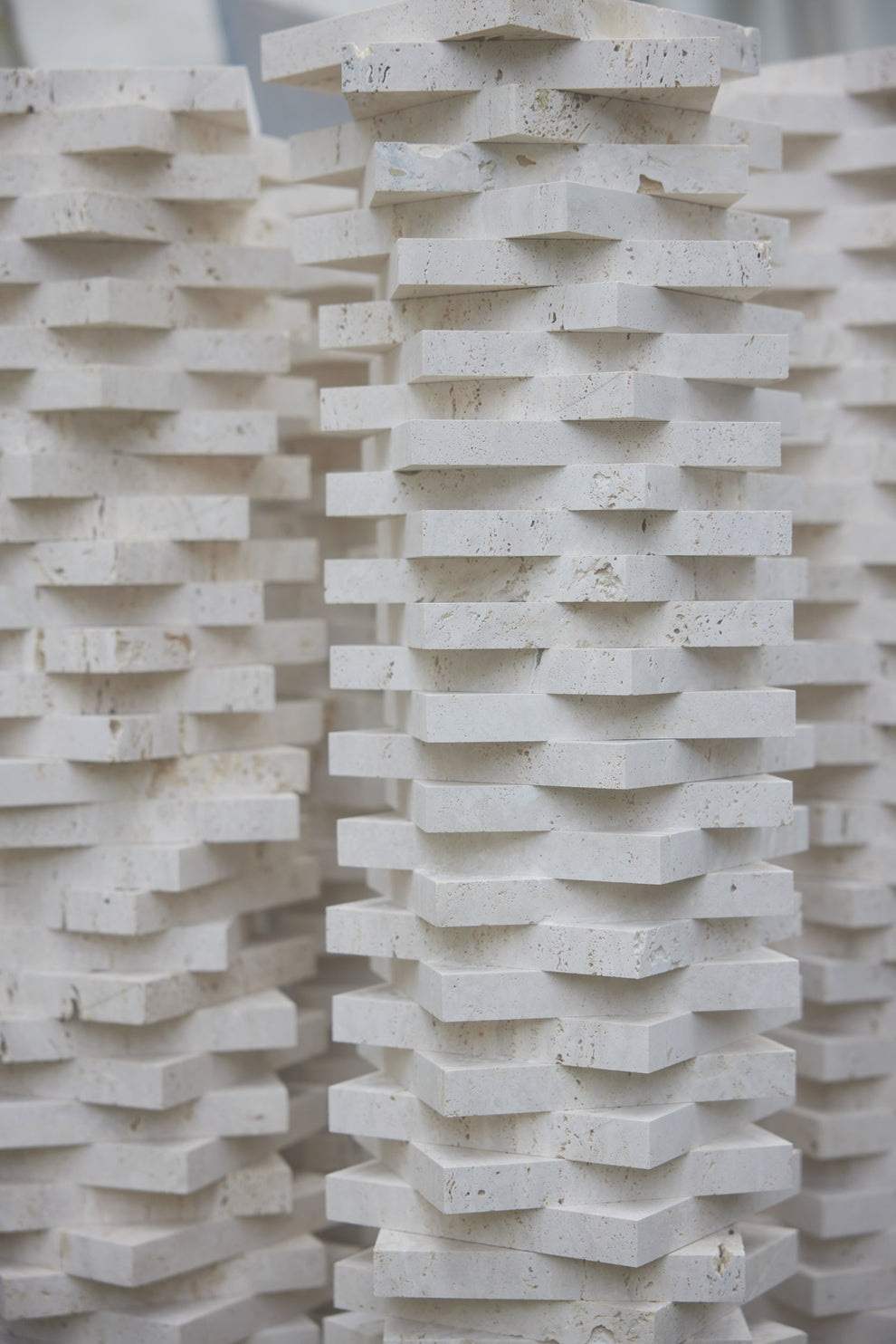 Geometrical stack of travertin square trays 