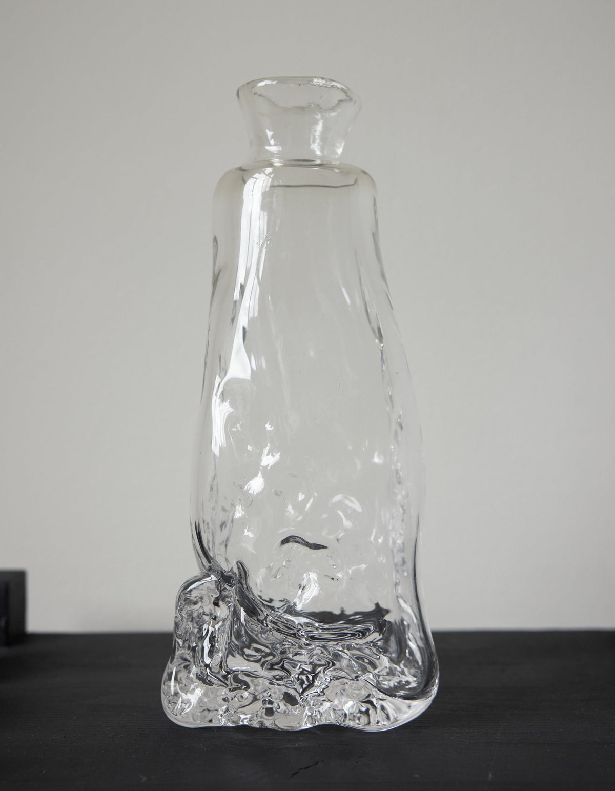 Blown vase | Glass: Hand-blown clear glass vase with an organic, melting form, showcasing Szkło Studio's unique, functional art approach by Aleksandra and Wojciech Zawistowski.