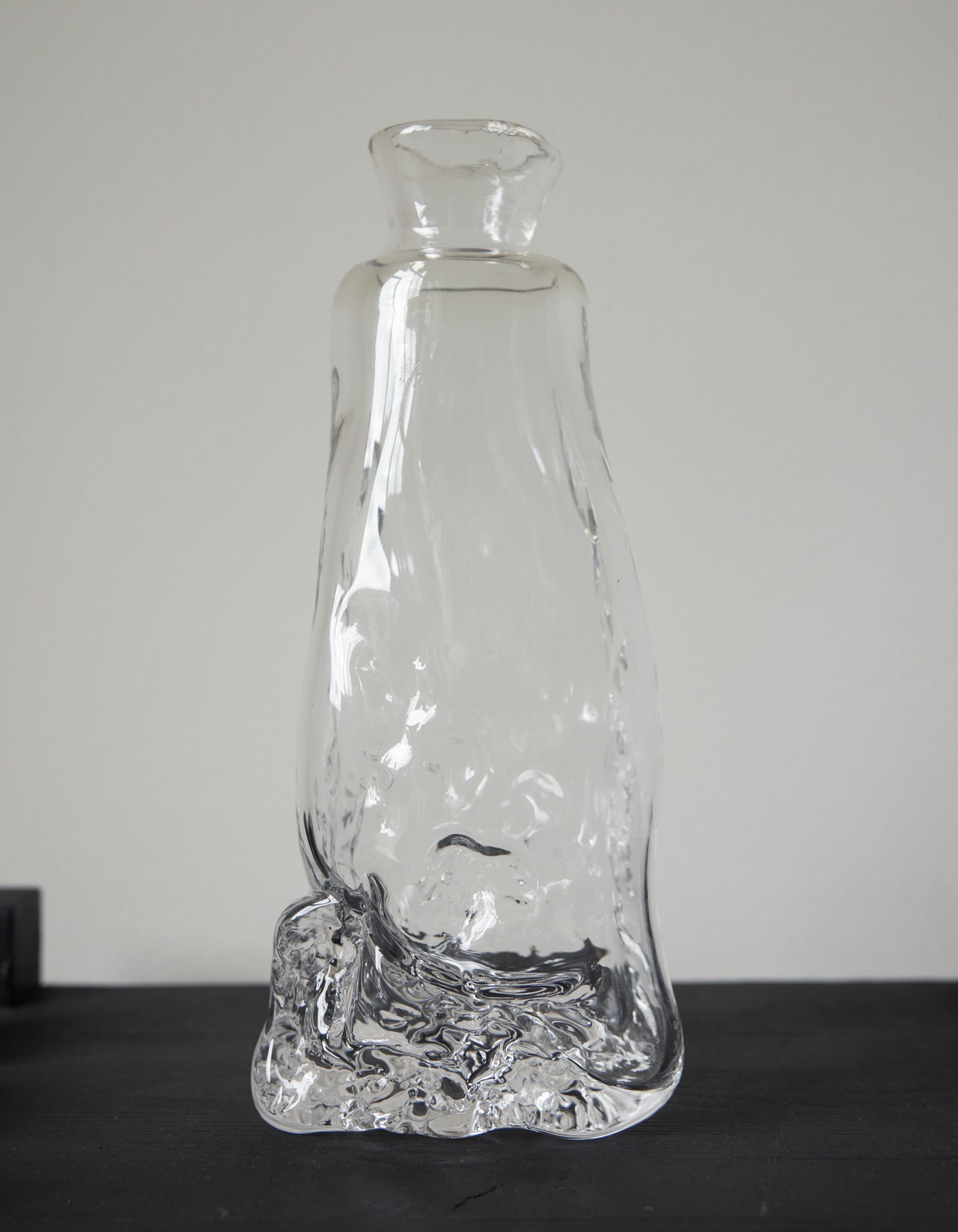 Blown vase | Glass: Hand-blown clear glass vase with an organic, melting form, showcasing Szkło Studio's unique, functional art approach by Aleksandra and Wojciech Zawistowski.