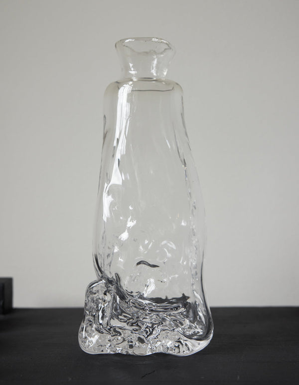 Blown vase | Glass: Hand-blown clear glass vase with an organic, melting form, showcasing Szkło Studio's unique, functional art approach by Aleksandra and Wojciech Zawistowski.