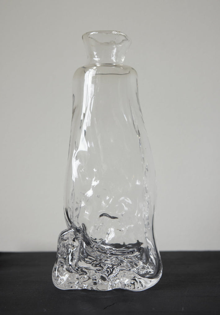 Blown vase | Glass: Hand-blown clear glass vase with an organic, melting form, showcasing Szkło Studio's unique, functional art approach by Aleksandra and Wojciech Zawistowski.