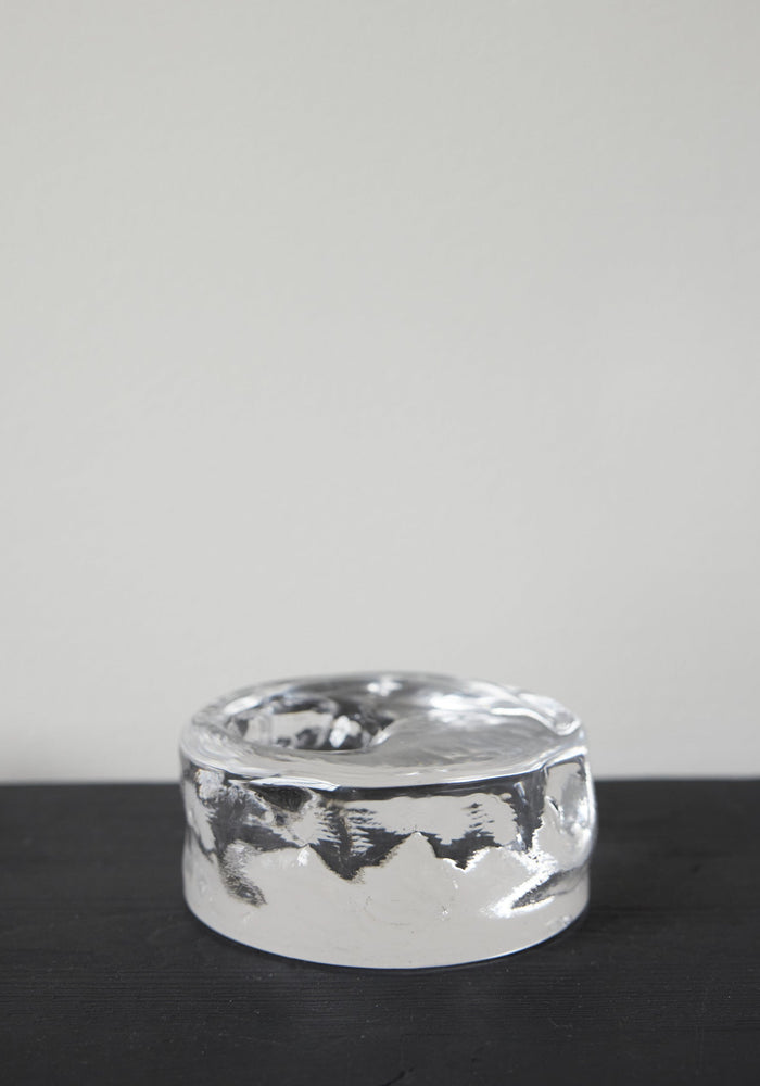 Presse-papier & holder: A thick, clear glass cylinder with undulating sides and a shallow top indentation, showcasing Szkło Studio's unique, hand-blown craftsmanship.