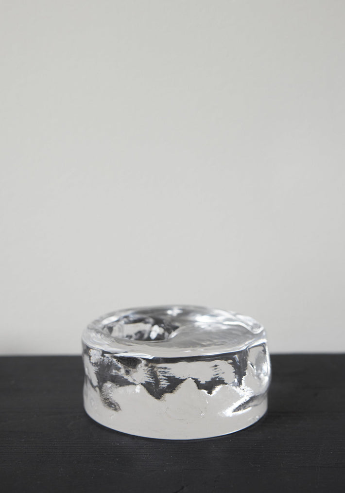 Presse-papier & holder: A thick, clear glass cylinder with undulating sides and a shallow top indentation, showcasing Szkło Studio's unique, hand-blown craftsmanship.