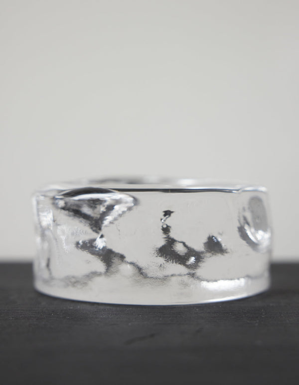 Presse-papier & holder | Glass: A smooth, clear glass-like cylinder with rippled sides, creating a wavy, liquid appearance, showcasing Szkło Studio's craftsmanship and unique design.