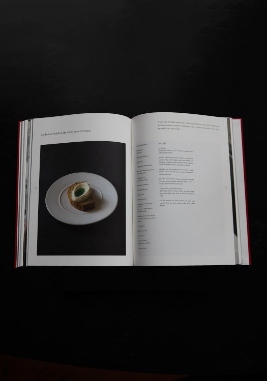 Open Róhe Cookbook | red showing a dessert recipe with a photo of a plated cake slice on the left page and recipe instructions on the right page against a dark background.