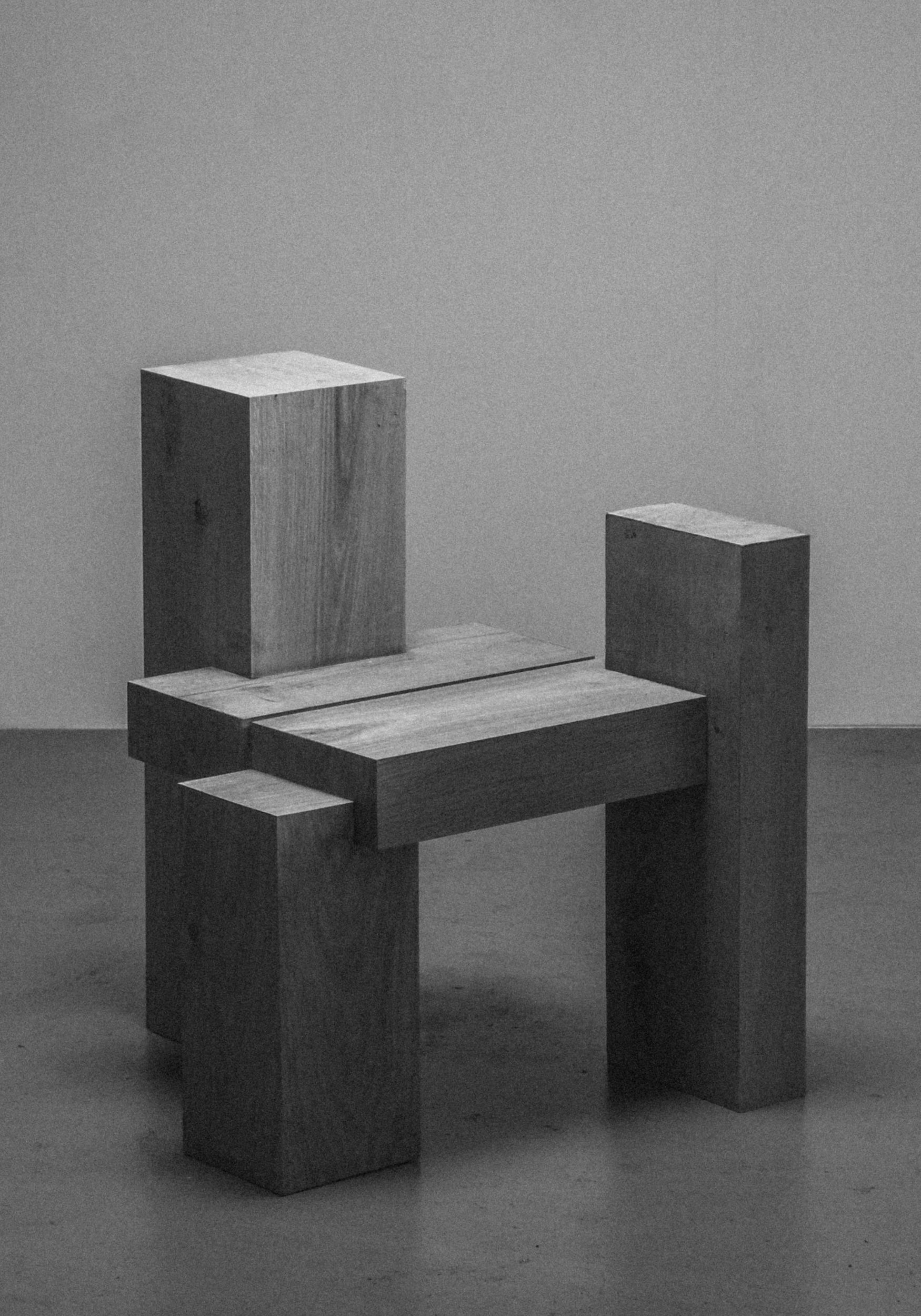 Geometric wooden chair with block-like design on a plain background