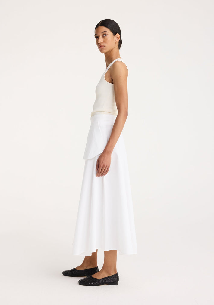 Bustier shaped knitted top in off white, worn by a model in profile, showcasing its fitted shape and bustier neckline, perfect for layering.