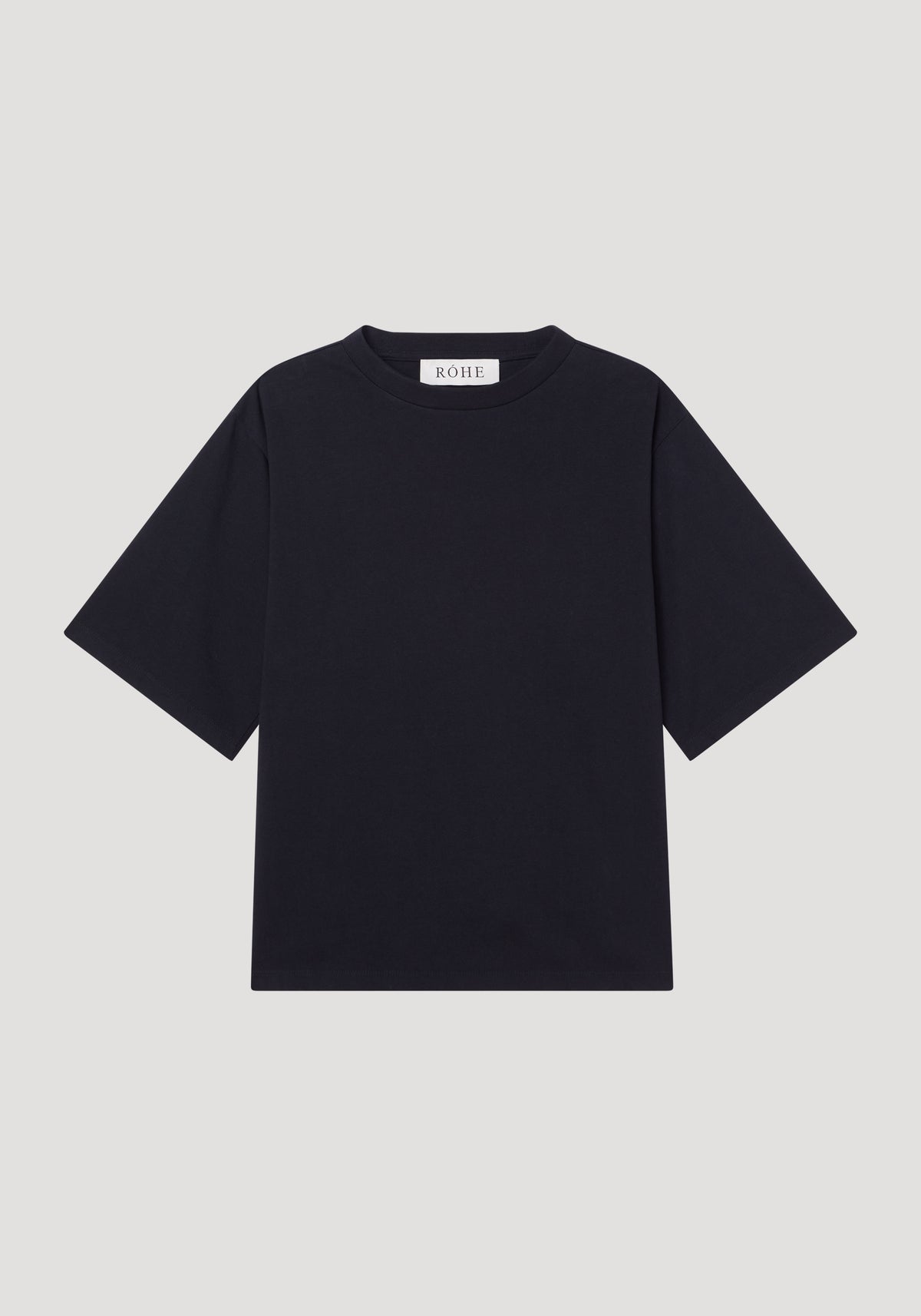 Oversized cotton t-shirt by RÓHE, featuring a plain black design with crew neck, short sleeves, and brand label at the collar, laid flat.